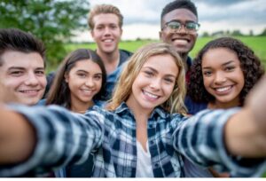 Teens taking group selfie